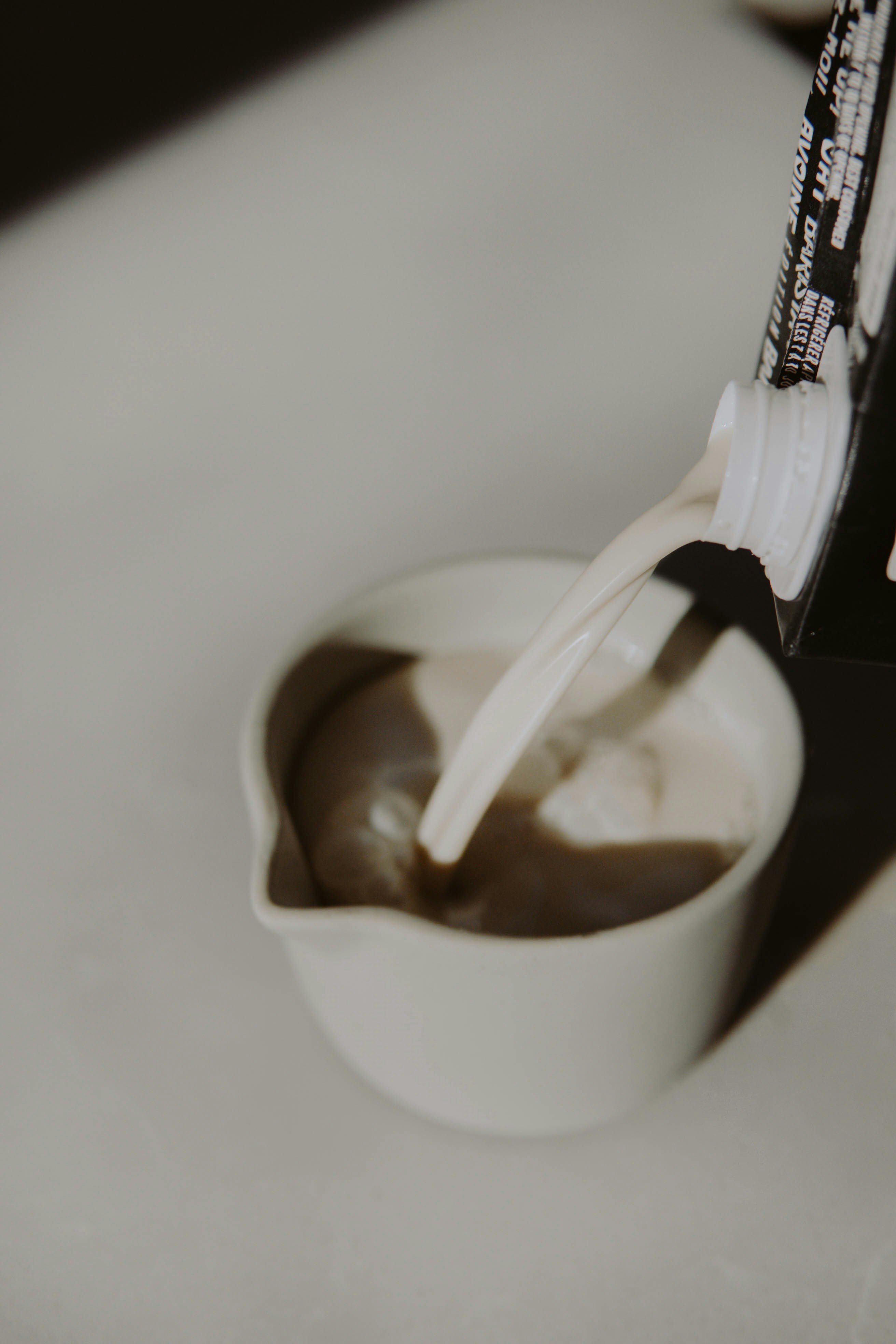 white ceramic mug with brown liquid